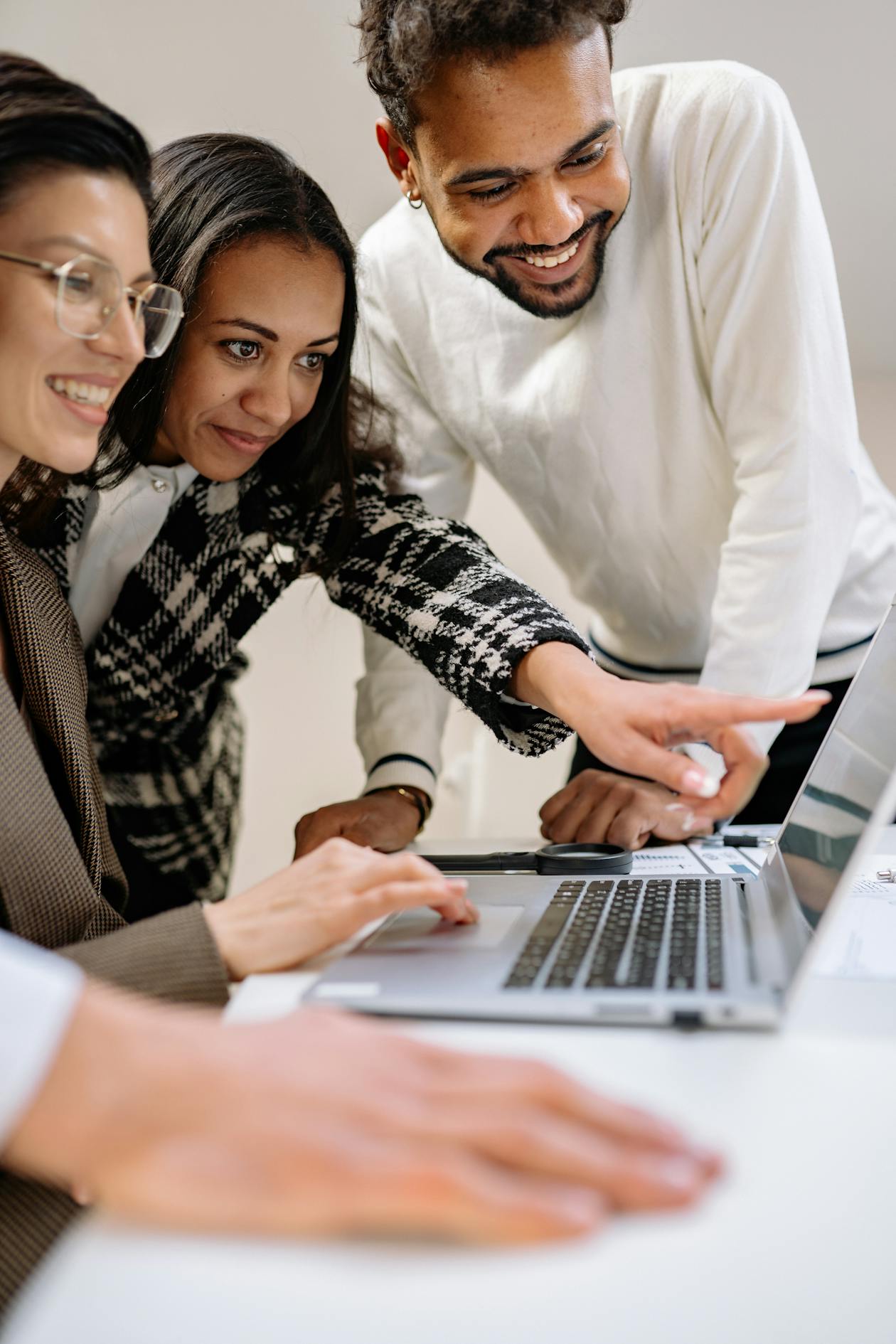Diverse team collaborating on a laptop